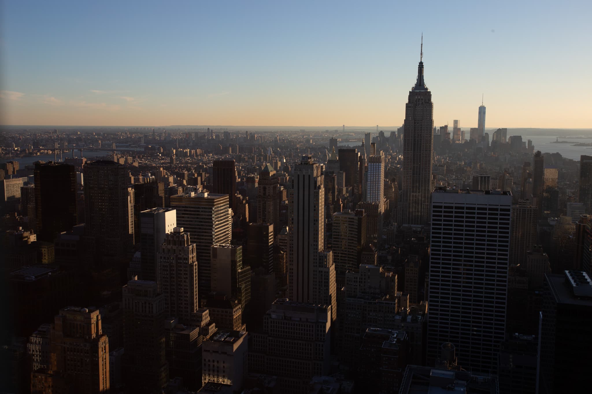 The Empire State Building rises over Manhattan in warm evening light